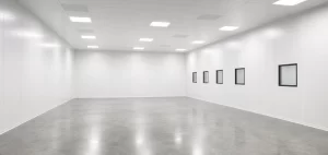 Inside a finished white modular cleanroom with solid wall panels and an LED grid ceiling.