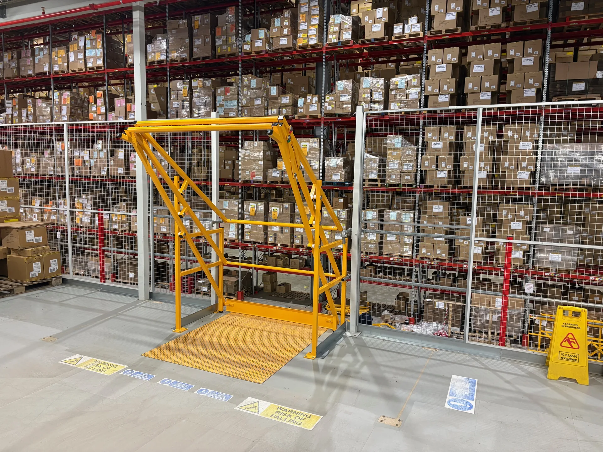 Yellow pallet gate on a mezzanine floor with mesh panels in Castleford