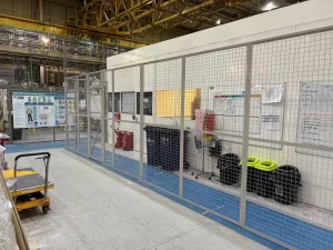 Mesh walkway partitioning running alongside a factory office in West Bromwich